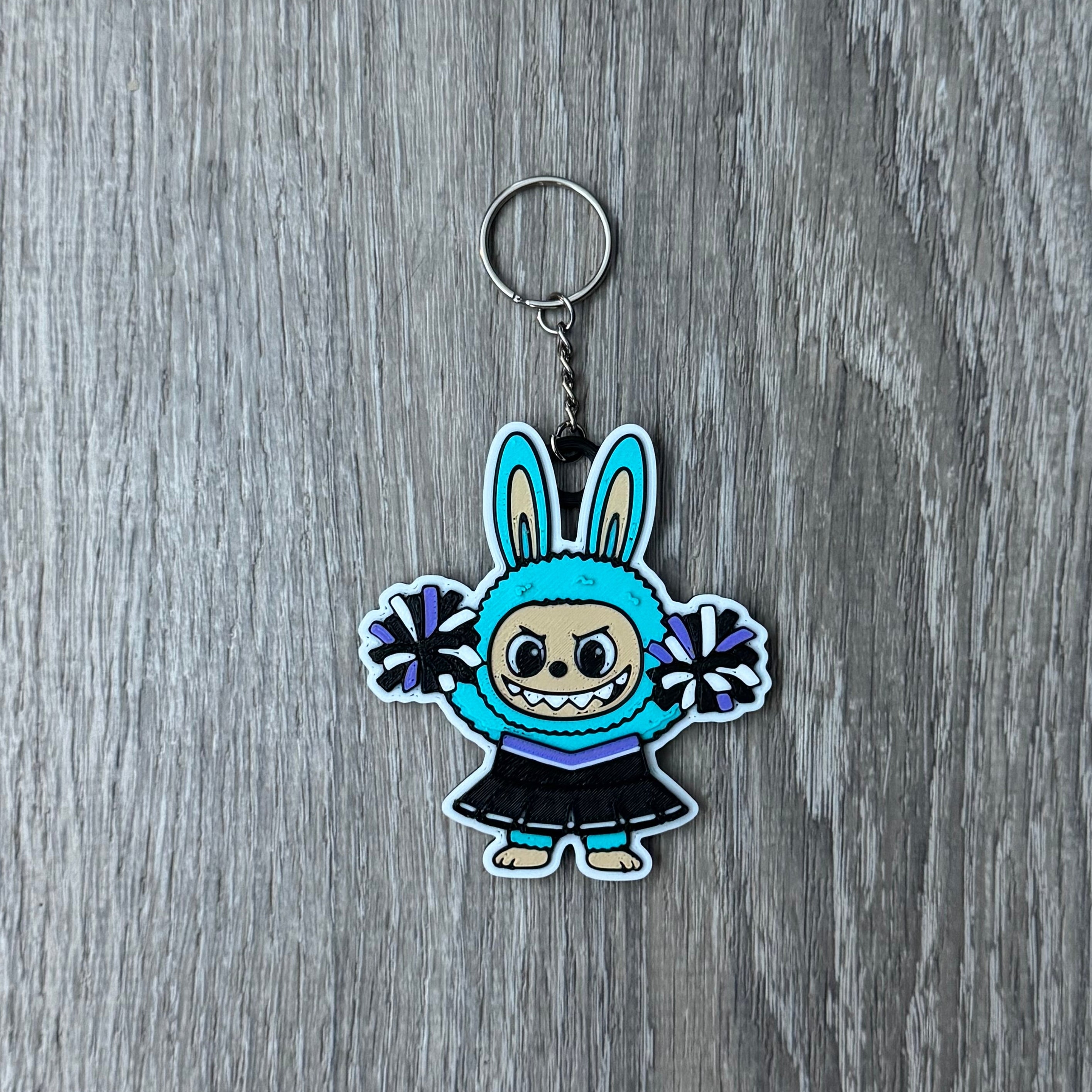 Keychain with cartoon character on a wooden surface
