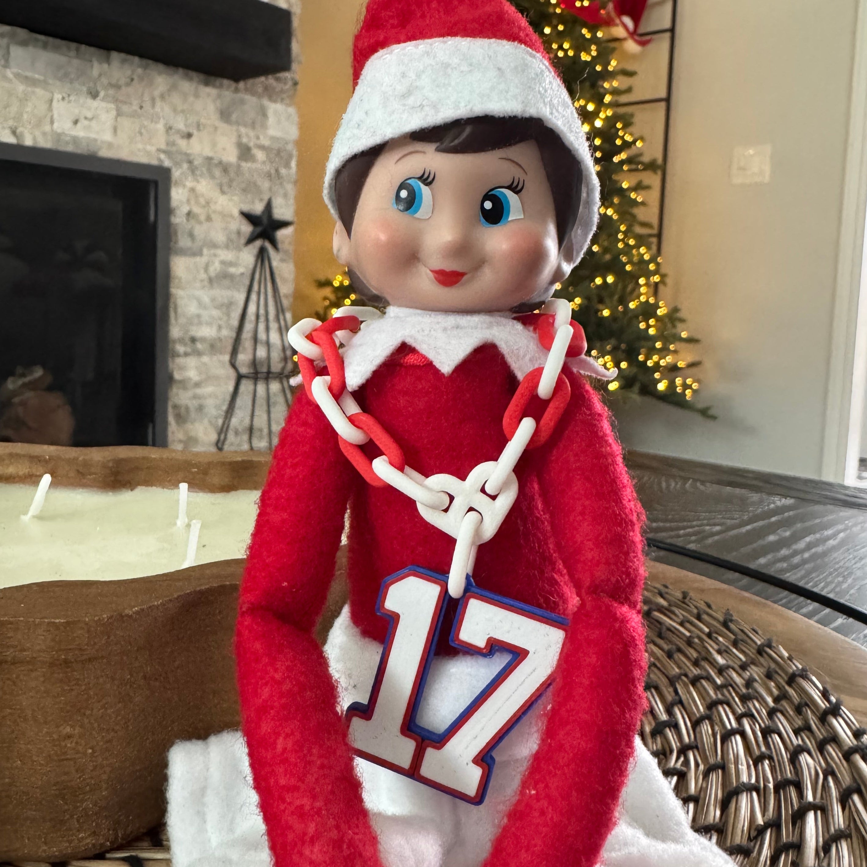 Elf on the Shelf wearing a red outfit with number 17 hype chain