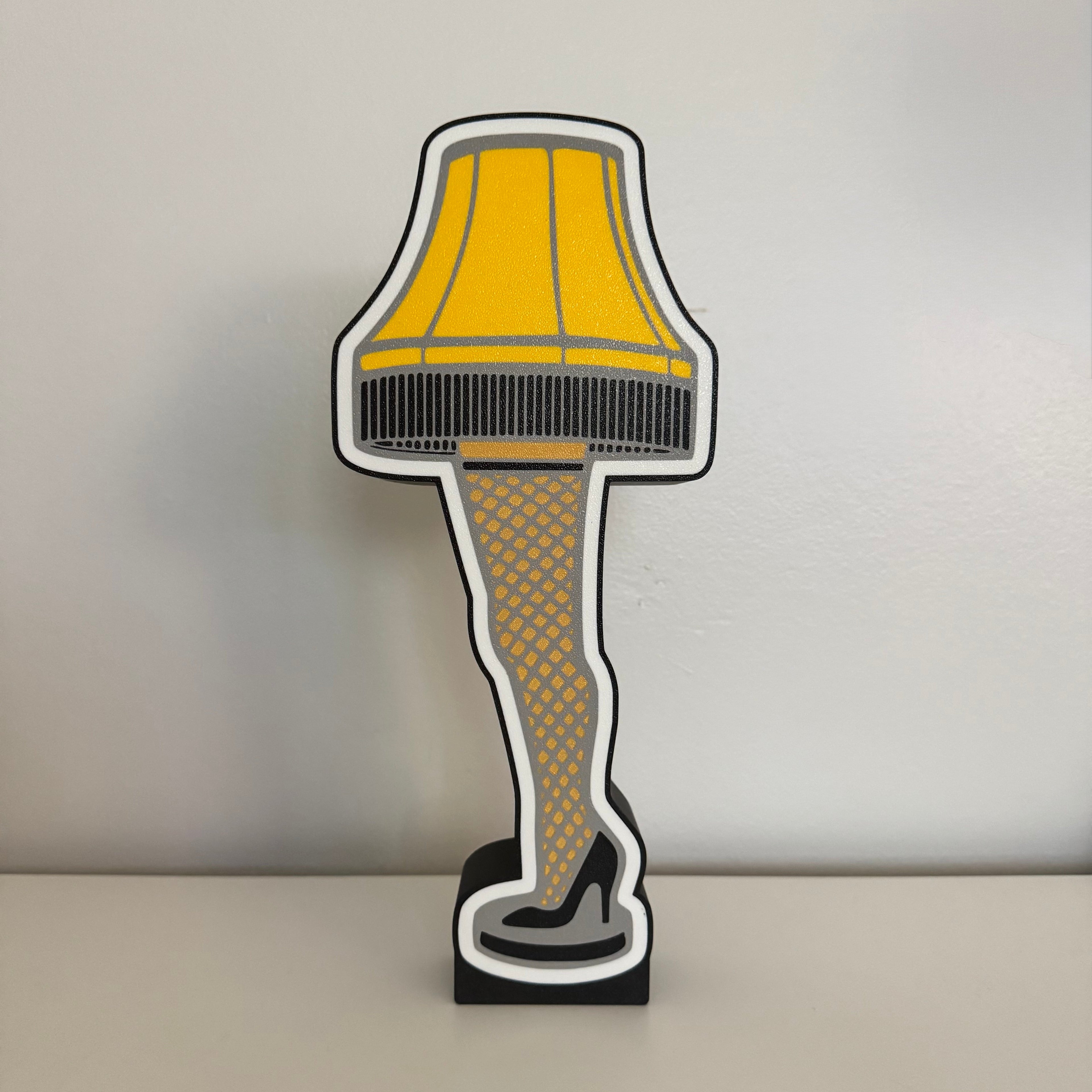 Decorative leg lamp with yellow shade on a plain background