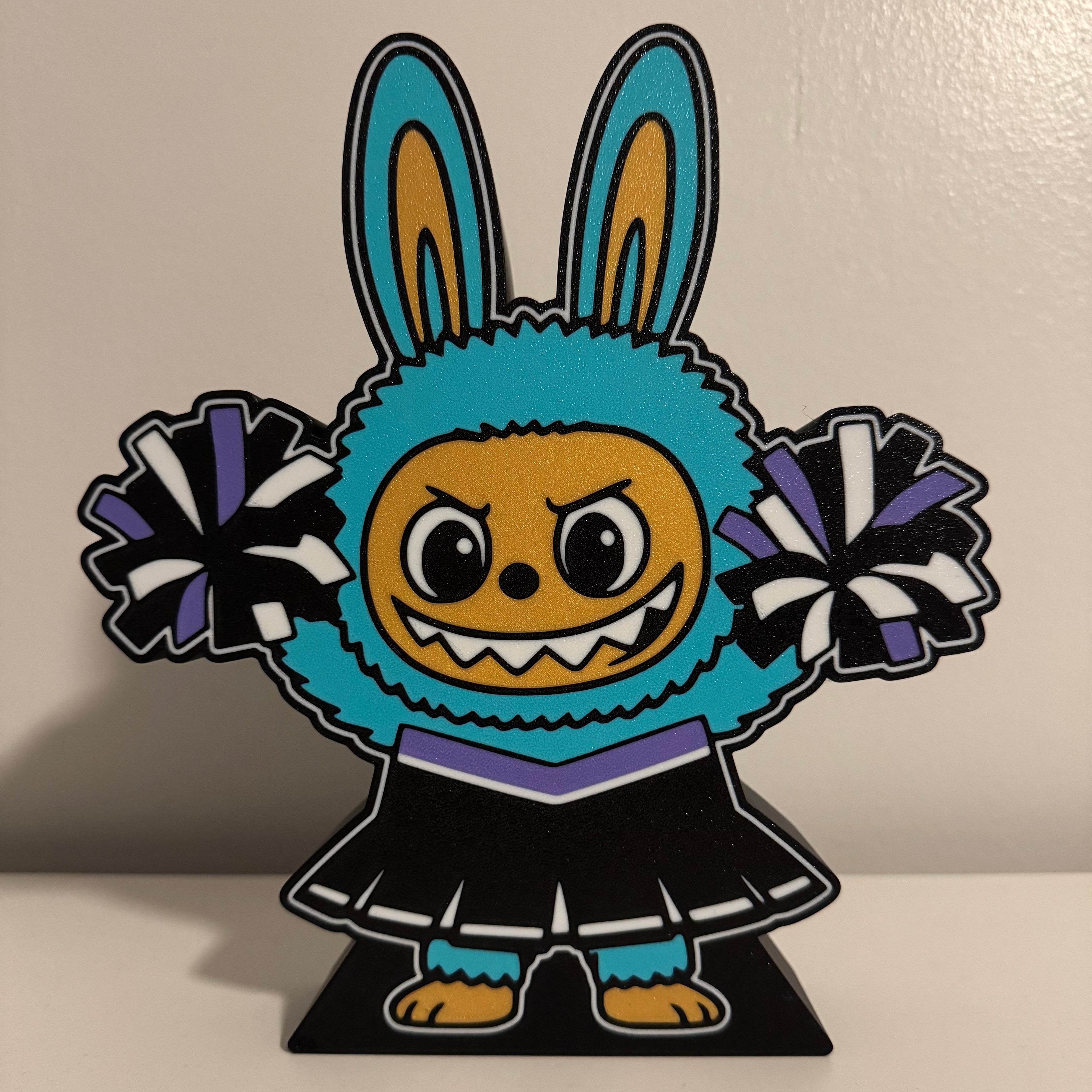 Colorful cartoon character with pom poms on a plain background